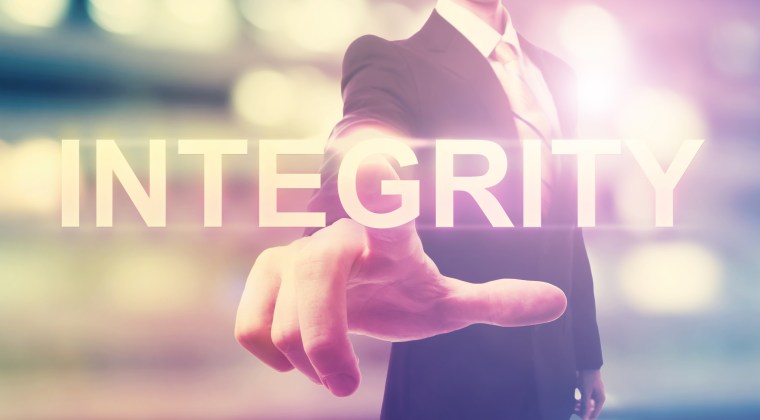 Businessman pointing at INTEGRITY